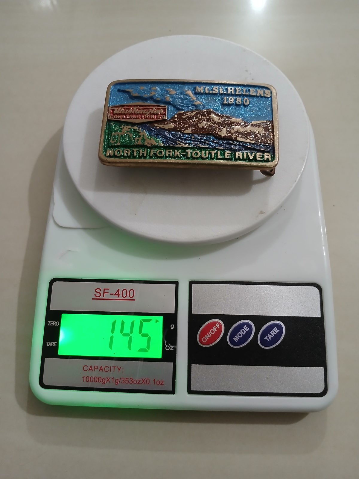 Washington Construction North Fork Toutle River Vintage Belt Buckle – On scale showing weight Washington Construction North Fork Toutle River vintage belt buckle – on scale showing weight