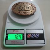 Whiskey Canyon Ranch vintage belt buckle – on scale showing weight