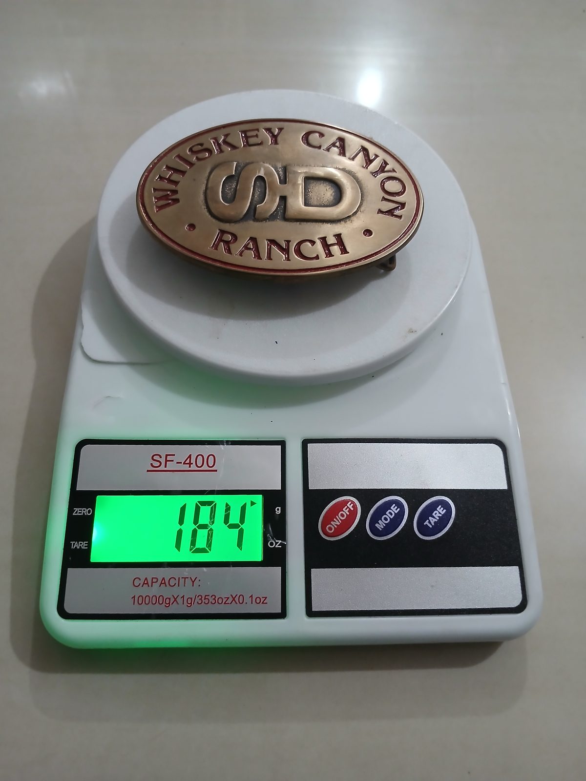 Whiskey Canyon Ranch Vintage Belt Buckle – On scale showing weight Whiskey Canyon Ranch vintage belt buckle – on scale showing weight